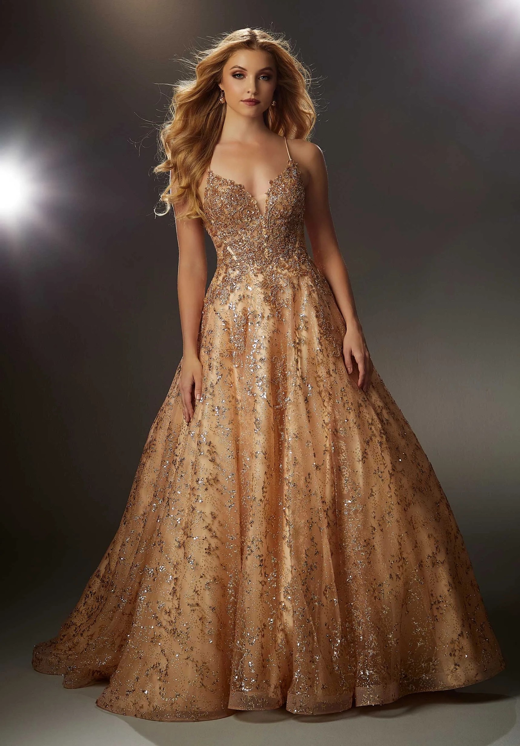 Model wearing a gold gown by Morilee