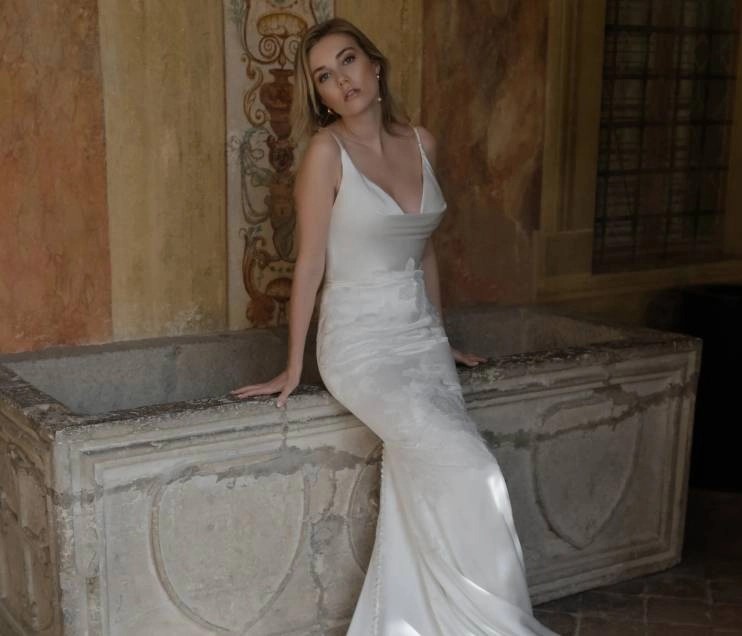 Model wearing a dress by Abella.