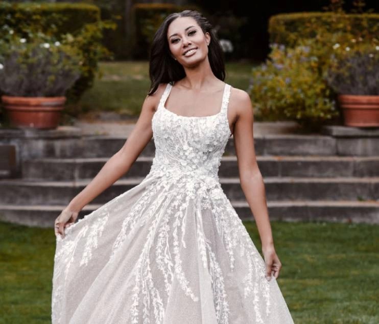Model wearing a dress by Allure Couture.